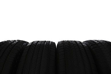 Set of new winter tires on white background, closeup Photo of Set of new winter tires on white background, closeup