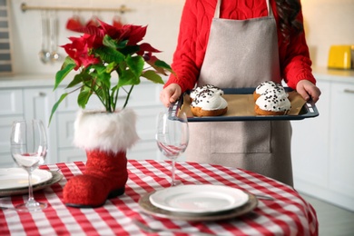 Woman with sweet buns for Christmas dinner in kitchen, closeup Photo of Woman with sweet buns for Christmas dinner in kitchen, closeup