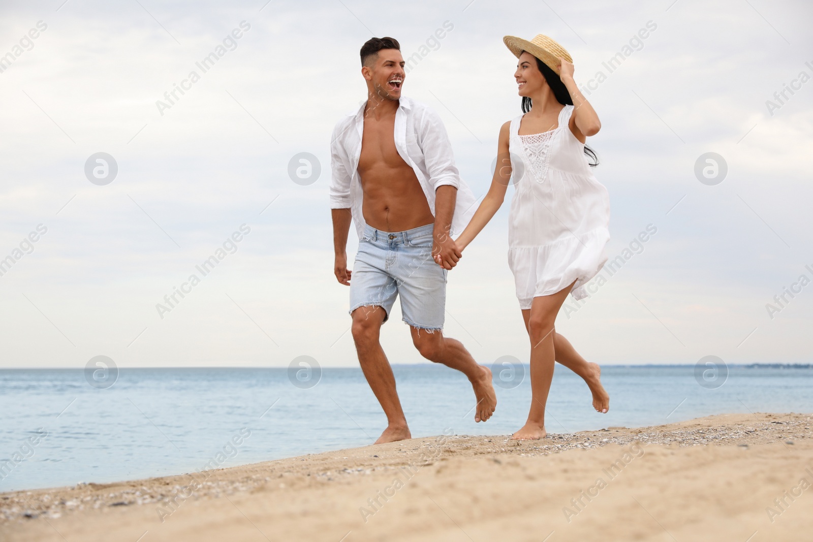 Lovely couple having fun on beautiful beach Photo of Lovely couple having fun on beautiful beach