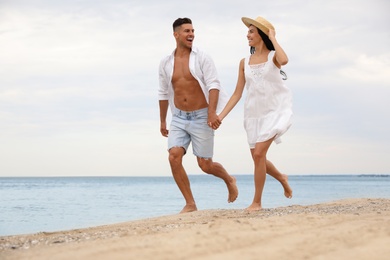 Lovely couple having fun on beautiful beach Photo of Lovely couple having fun on beautiful beach