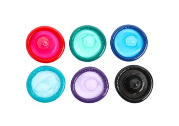 Unpacked colorful condoms on white background, top view. Safe sex Photo of Unpacked colorful condoms on white background, top view. Safe sex
