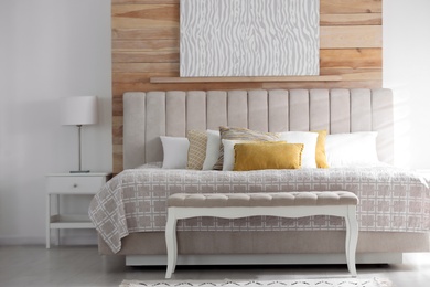 Comfortable bed with soft color pillows indoors Photo of Comfortable bed with soft color pillows indoors