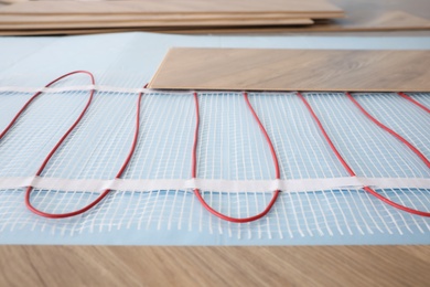 Installation of modern underfloor trace heating system indoors, closeup Photo of Installation of modern underfloor trace heating system indoors, closeup