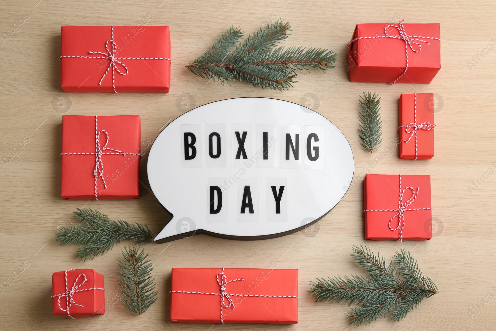 Flat lay composition with Boxing Day sign and Christmas gifts on wooden table Photo of Flat lay composition with Boxing Day sign and Christmas gifts on wooden table