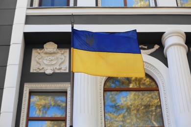 National flag of Ukraine on vintage building wall outdoors Photo of National flag of Ukraine on vintage building wall outdoors