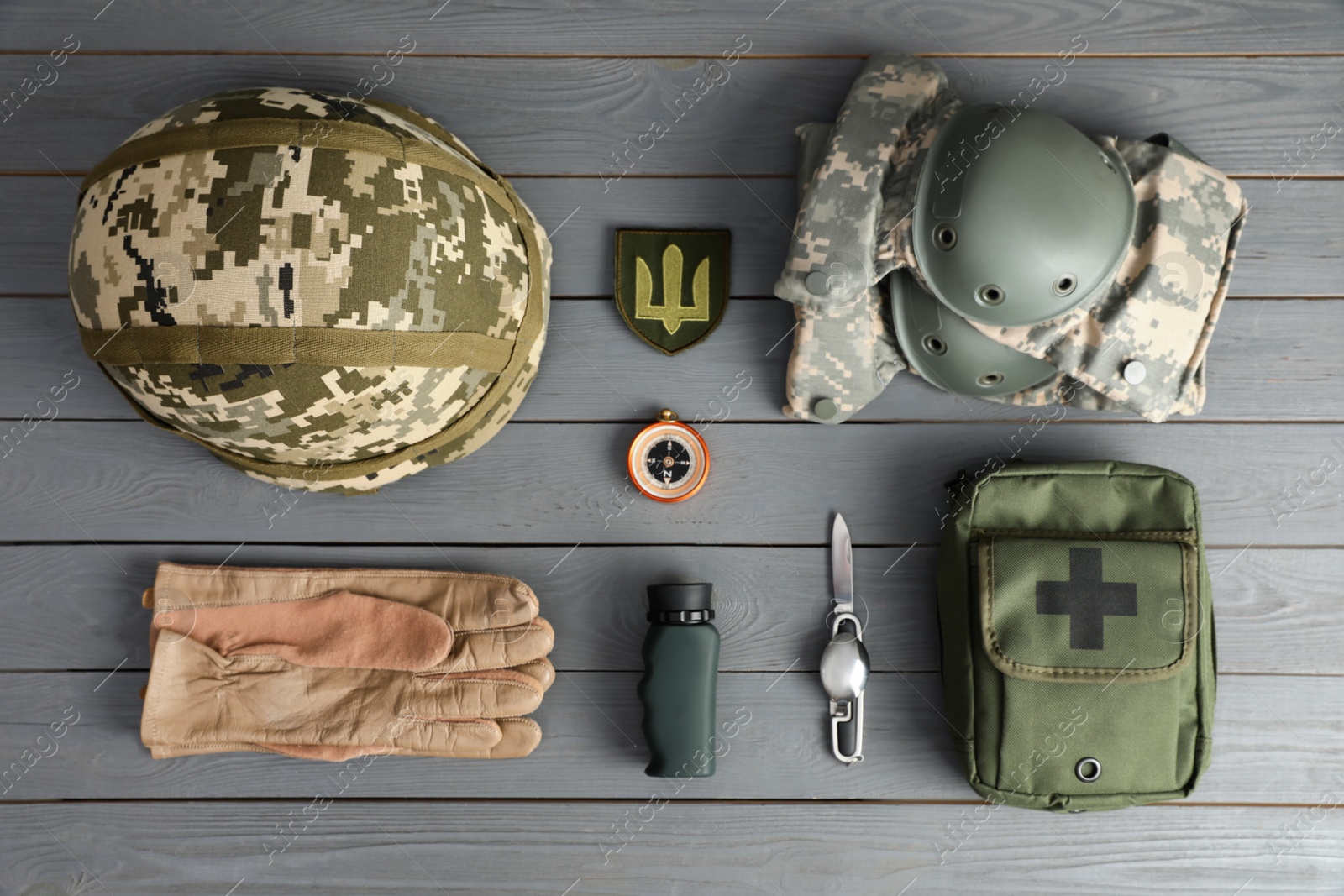 MYKOLAIV, UKRAINE - SEPTEMBER 26, 2020: Tactical gear and Ukrainian army patch on grey table, flat lay Photo of MYKOLAIV, UKRAINE - SEPTEMBER 26, 2020: Tactical gear and Ukrainian army patch on grey table, flat lay