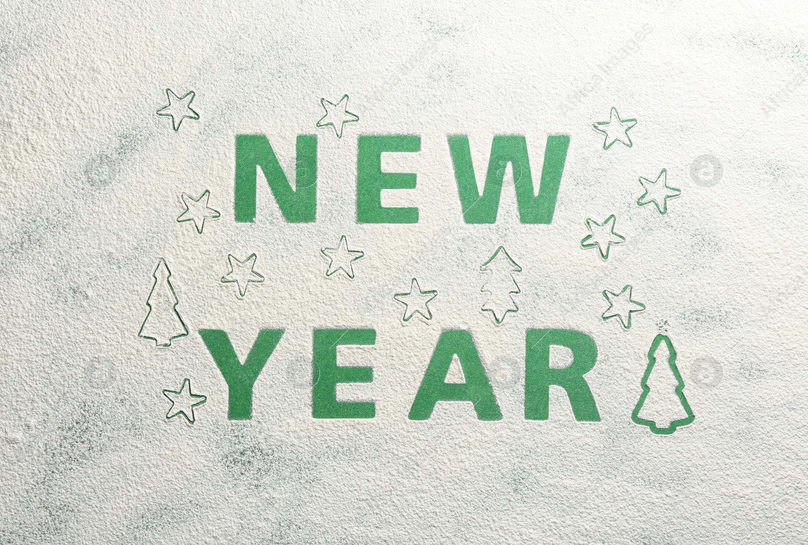 Words NEW YEAR made of flour on green background, top view Photo of Words NEW YEAR made of flour on green background, top view
