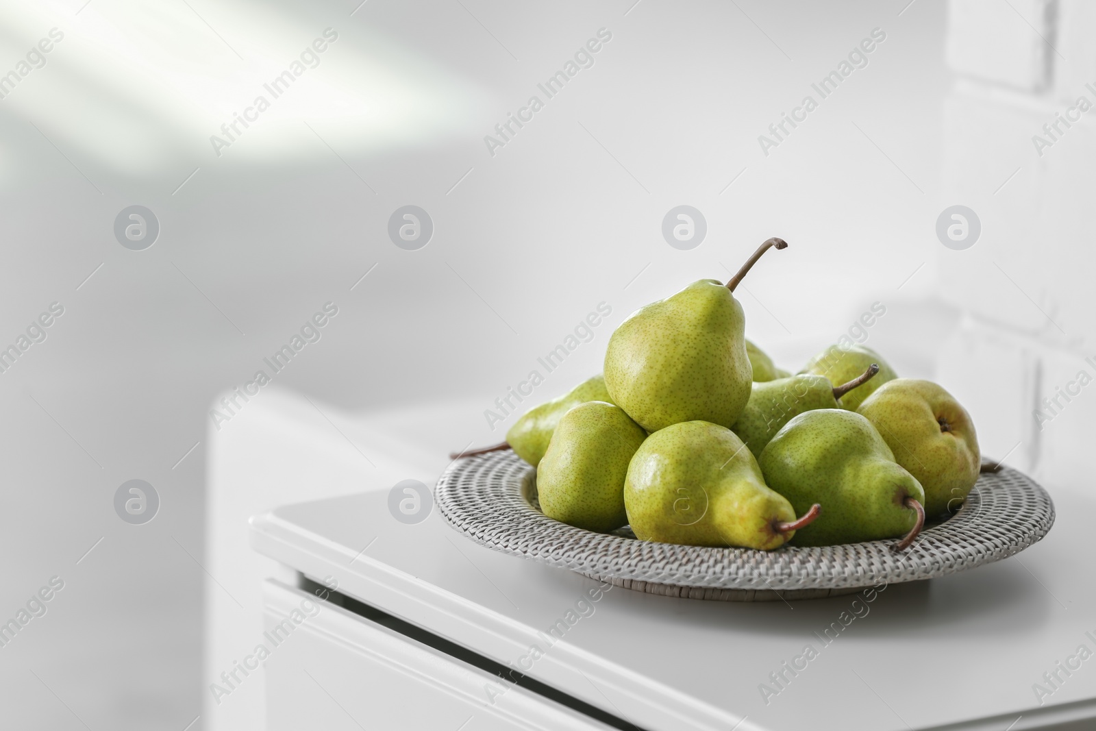 Fresh ripe pears on white table in room. Space for text Photo of Fresh ripe pears on white table in room. Space for text