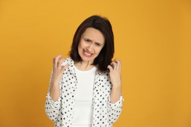 Portrait of angry woman on yellow background. Hate concept Photo of Portrait of angry woman on yellow background. Hate concept