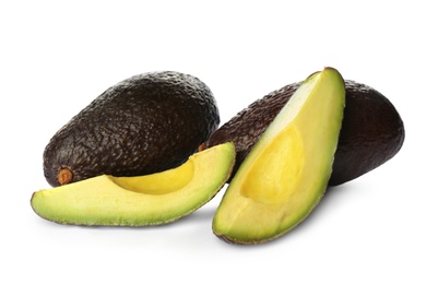 Cut and whole ripe avocadoes on white background Photo of Cut and whole ripe avocadoes on white background