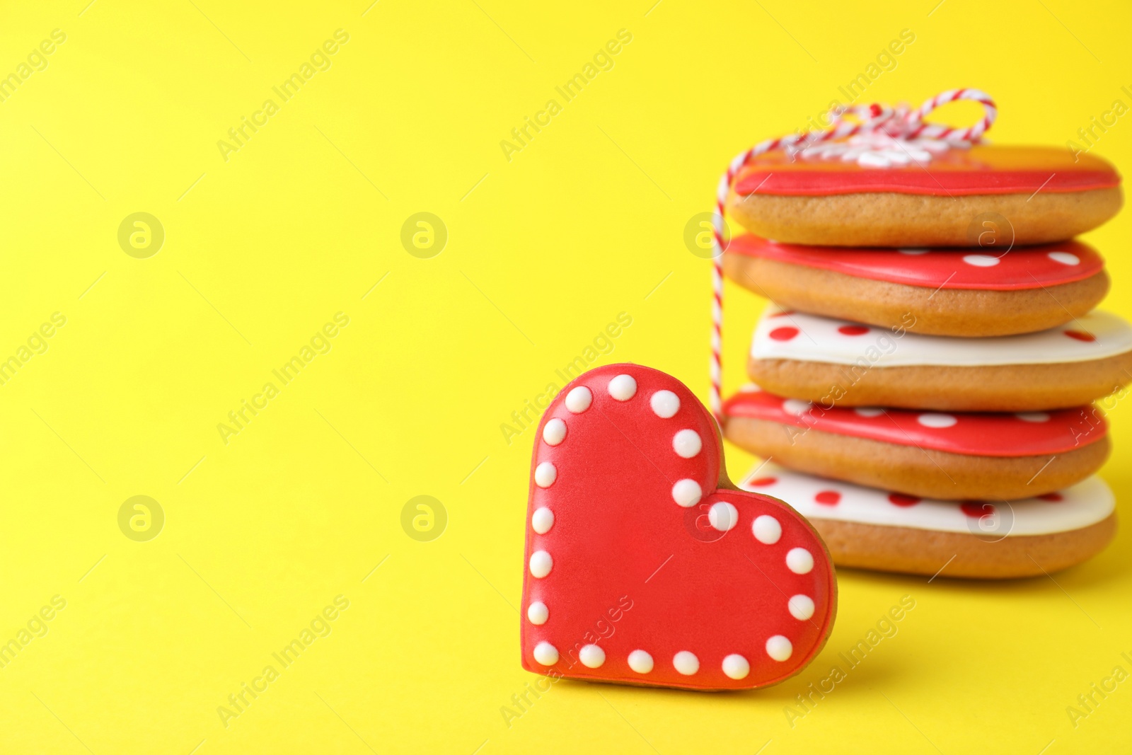 Gift set of heart shaped cookies on yellow background, closeup with space for text. Valentine's day treat Photo of Gift set of heart shaped cookies on yellow background, closeup with space for text. Valentine's day treat