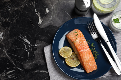 Flat lay composition with cooked red fish on dark marble table, space for text Photo of Flat lay composition with cooked red fish on dark marble table, space for text