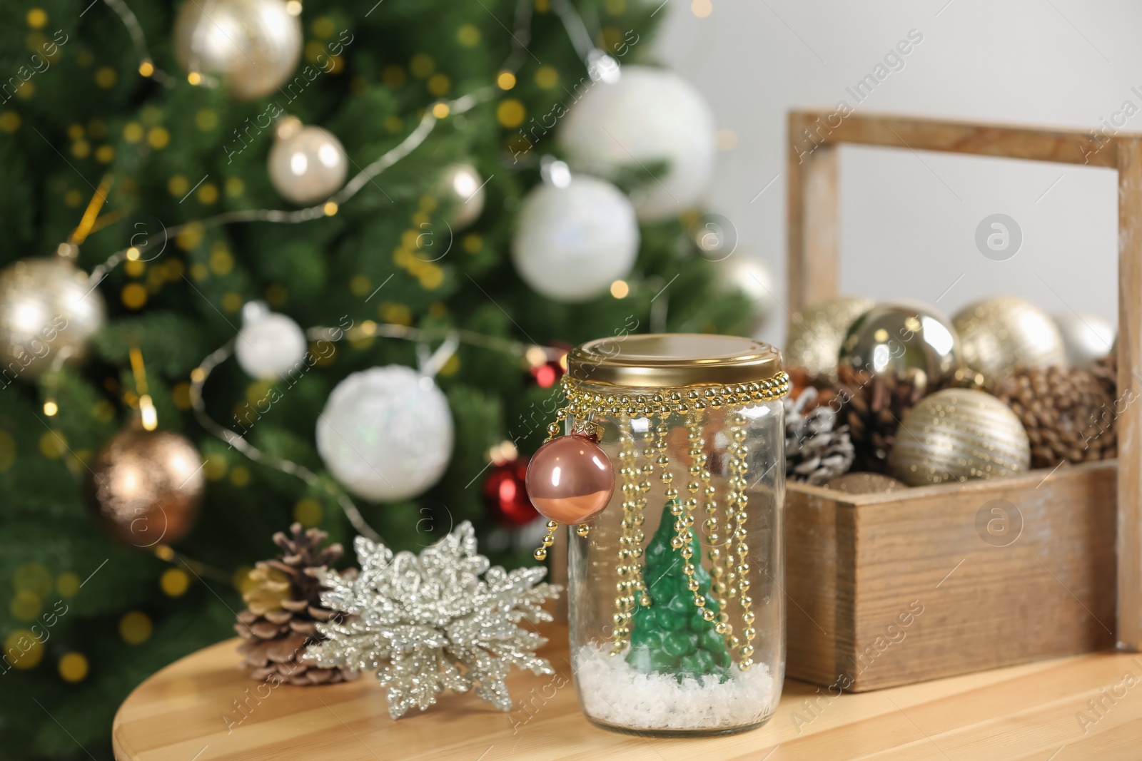 Handmade snow globe and Christmas decorations on wooden table Photo of Handmade snow globe and Christmas decorations on wooden table