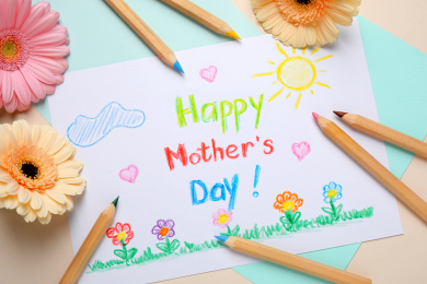 Flat lay composition with drawing for Mother's day on white wooden background Photo of Flat lay composition with drawing for Mother's day on white wooden background