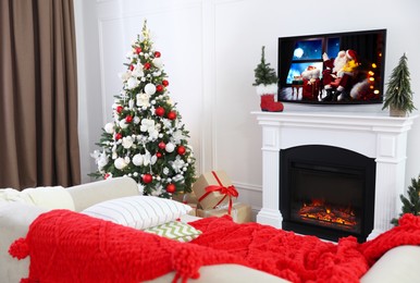 Stylish living room interior with TV set, Christmas tree and fireplace Image of Stylish living room interior with TV set, Christmas tree and fireplace