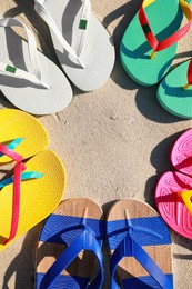Stylish flip flops on beach, flat lay. Space for text Photo of Stylish flip flops on beach, flat lay. Space for text