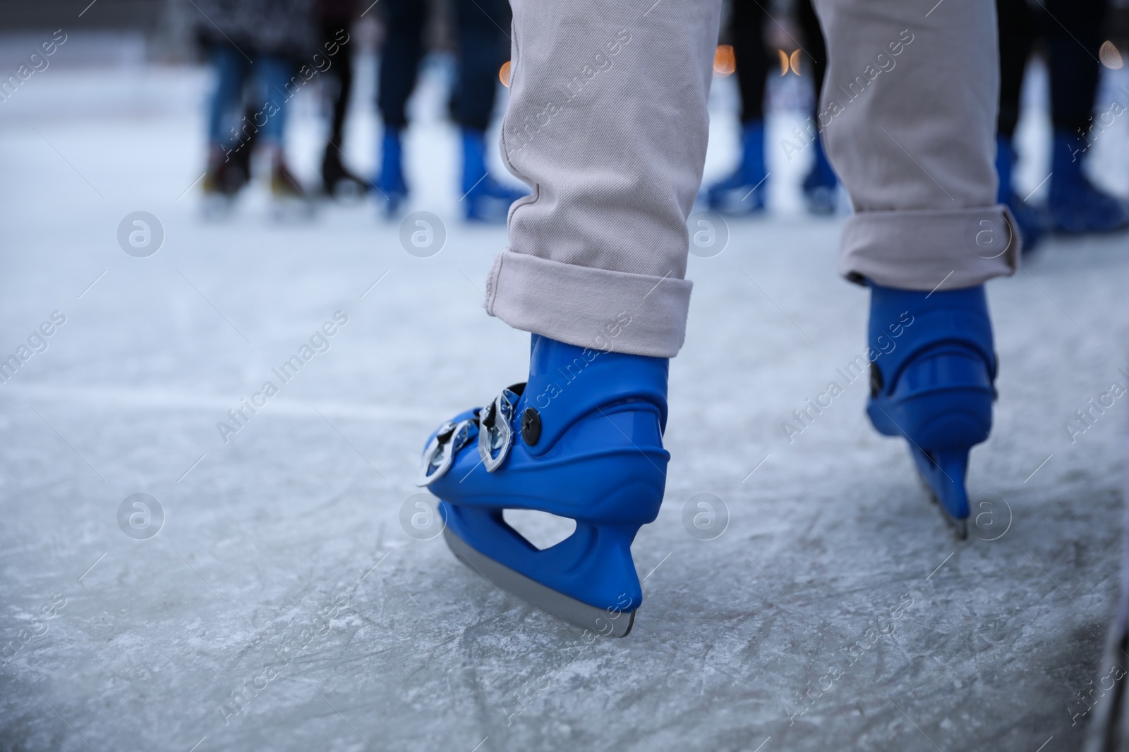 Person skating at outdoor ice rink, closeup Photo of Person skating at outdoor ice rink, closeup