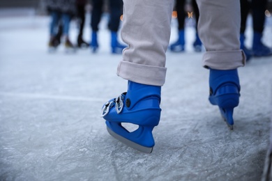 Person skating at outdoor ice rink, closeup Photo of Person skating at outdoor ice rink, closeup