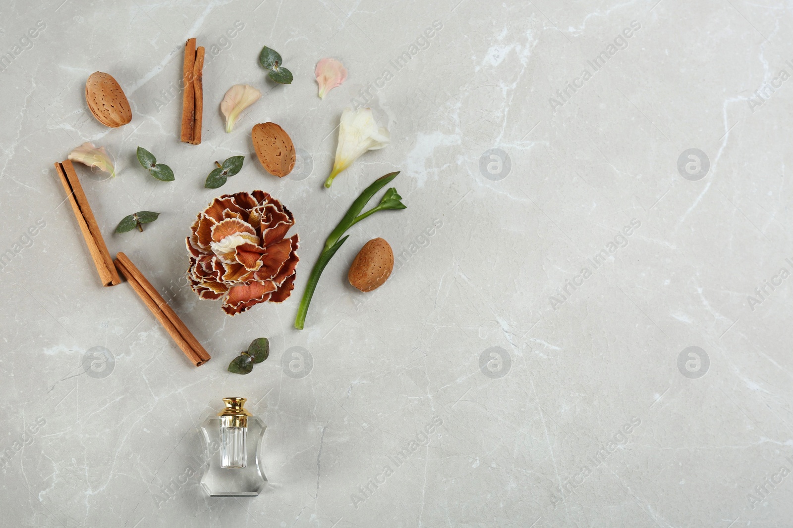 Flat lay composition with bottle of perfume on marble background, space for text Photo of Flat lay composition with bottle of perfume on marble background, space for text