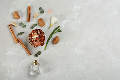 Flat lay composition with bottle of perfume on marble background, space for text Photo of Flat lay composition with bottle of perfume on marble background, space for text