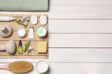 Flat lay composition with spa essentials on white wooden background. Space for text Photo of Flat lay composition with spa essentials on white wooden background. Space for text