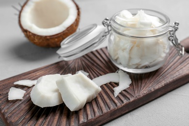 Fresh coconut flakes in glass jar on light background Photo of Fresh coconut flakes in glass jar on light background