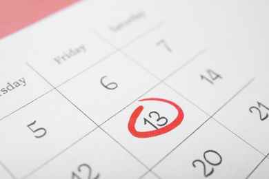 Calendar page with marked Friday 13, closeup. Bad luck superstition Photo of Calendar page with marked Friday 13, closeup. Bad luck superstition