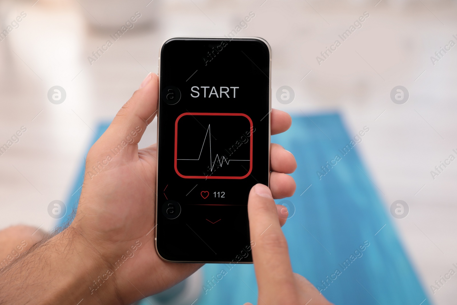 Man using fitness app on smartphone indoors, closeup Photo of Man using fitness app on smartphone indoors, closeup