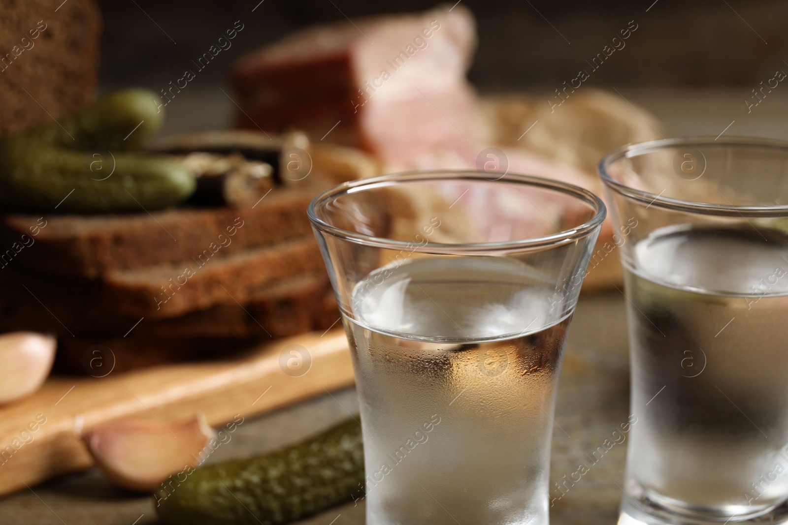 Cold traditional Russian vodka on table, closeup view Photo of Cold traditional Russian vodka on table, closeup view
