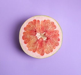 Fresh cut pomelo fruit on lilac background, top view Photo of Fresh cut pomelo fruit on lilac background, top view