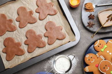 Flat lay composition with homemade gingerbread man cookies on black table Photo of Flat lay composition with homemade gingerbread man cookies on black table