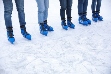 Friends at ice skating rink outdoors, closeup. Space for text Photo of Friends at ice skating rink outdoors, closeup. Space for text