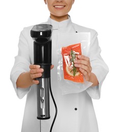 Chef holding sous vide cooker and salmon in vacuum pack on white background, closeup Photo of Chef holding sous vide cooker and salmon in vacuum pack on white background, closeup