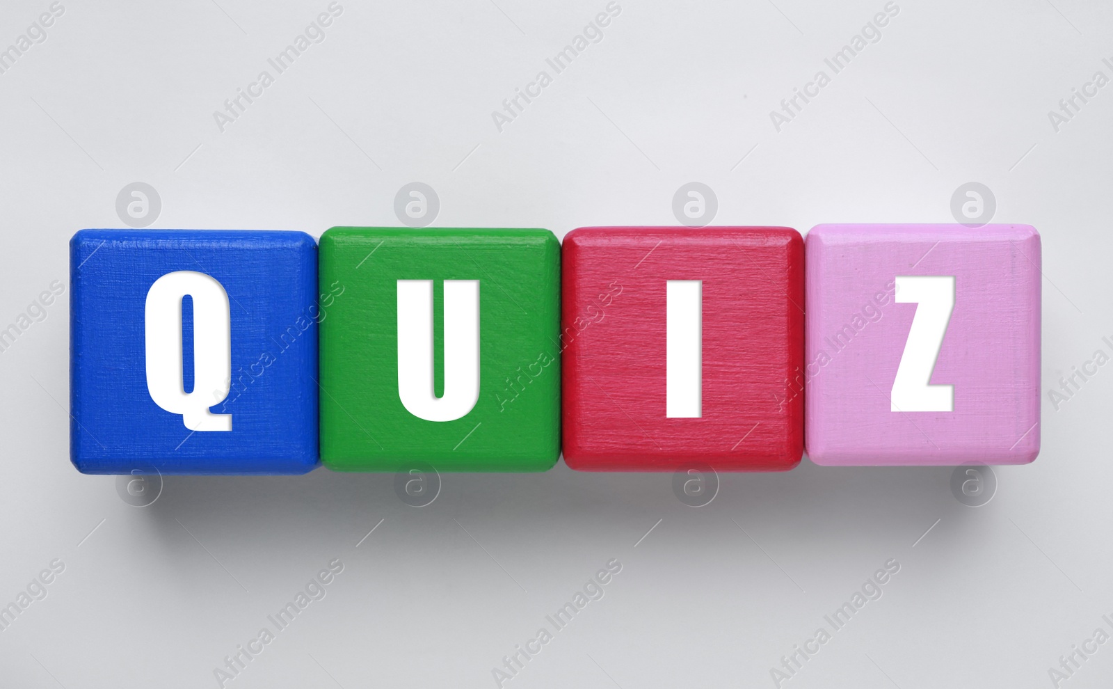 Colorful cubes with word Quiz on white background, top view Photo of Colorful cubes with word Quiz on white background, top view