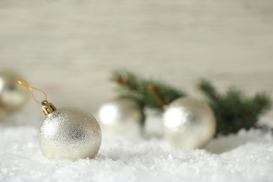 Beautiful Christmas ball on snow against blurred background. Space for text Photo of Beautiful Christmas ball on snow against blurred background. Space for text