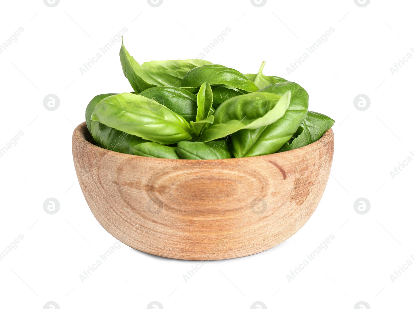 Photo of Fresh green basil leaves in wooden bowl isolated on white