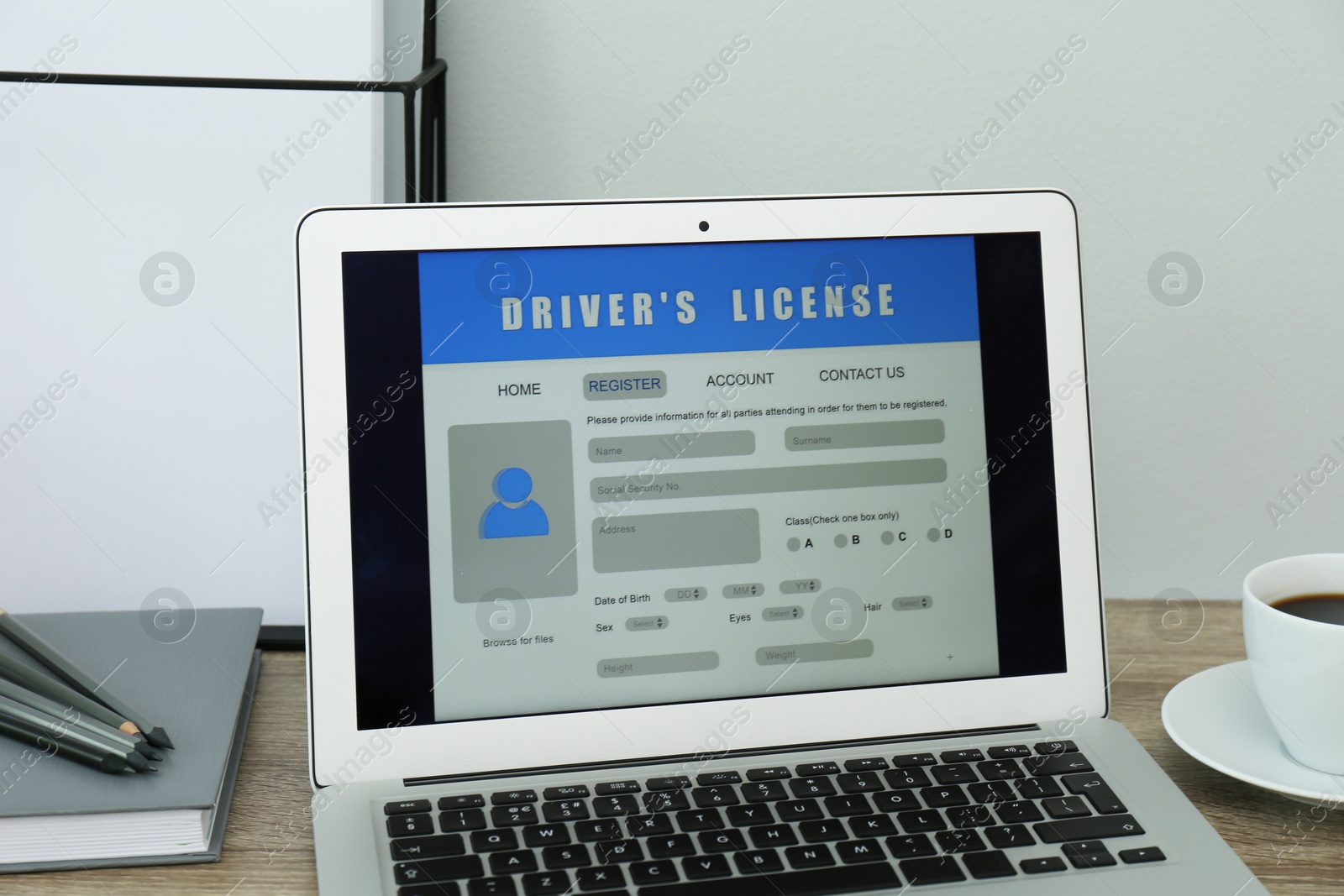 Laptop with driver's license application form on table in office Photo of Laptop with driver's license application form on table in office