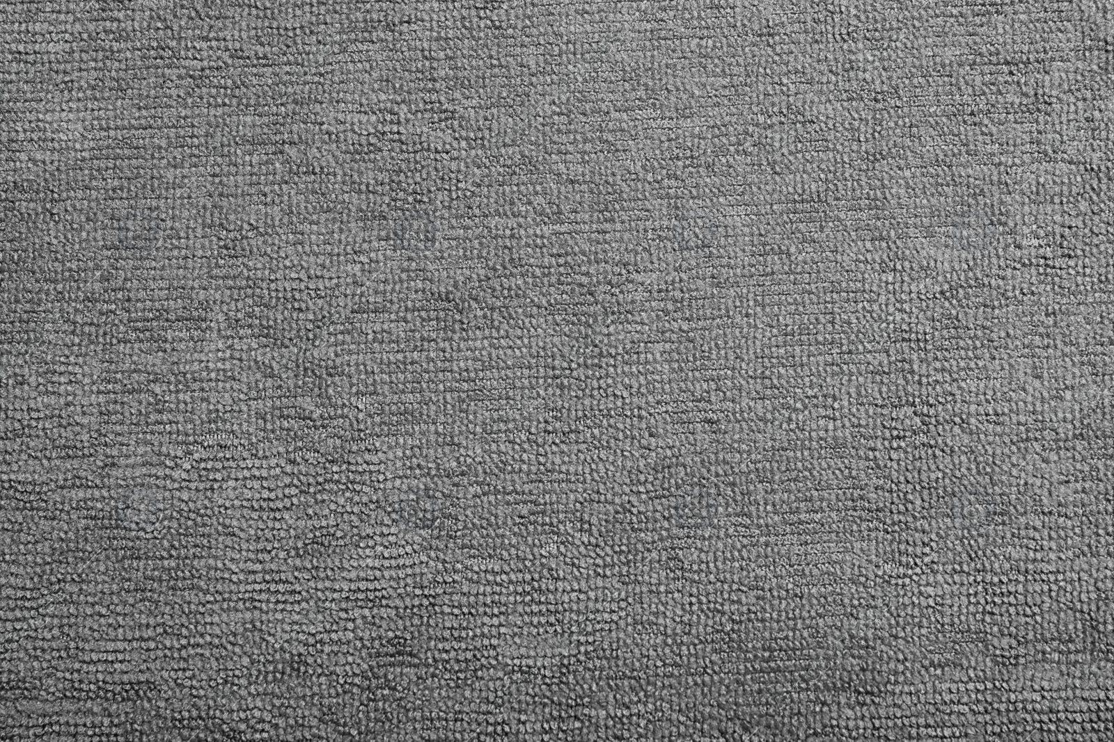 Grey microfiber cloth as background, top view Photo of Grey microfiber cloth as background, top view