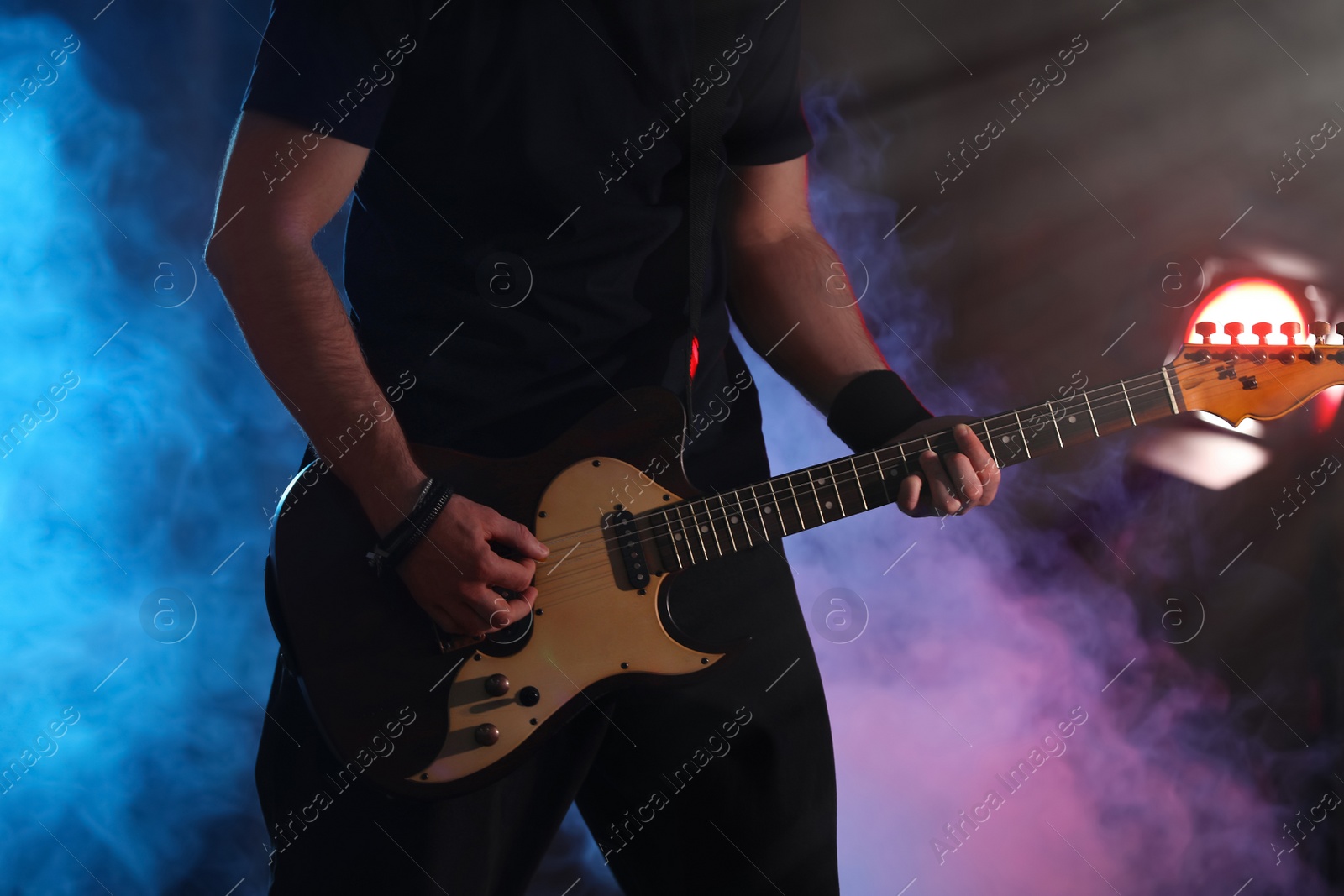 Man playing electric guitar on stage, closeup. Rock music Photo of Man playing electric guitar on stage, closeup. Rock music