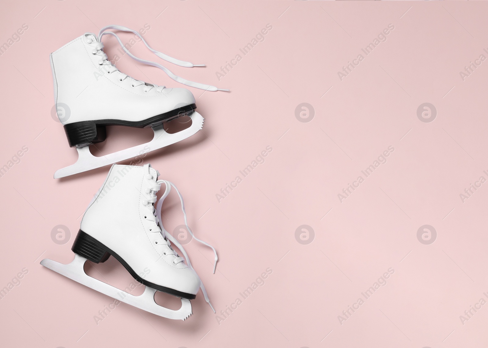 Pair of skates on color background, flat lay. Space for text Photo of Pair of skates on color background, flat lay. Space for text