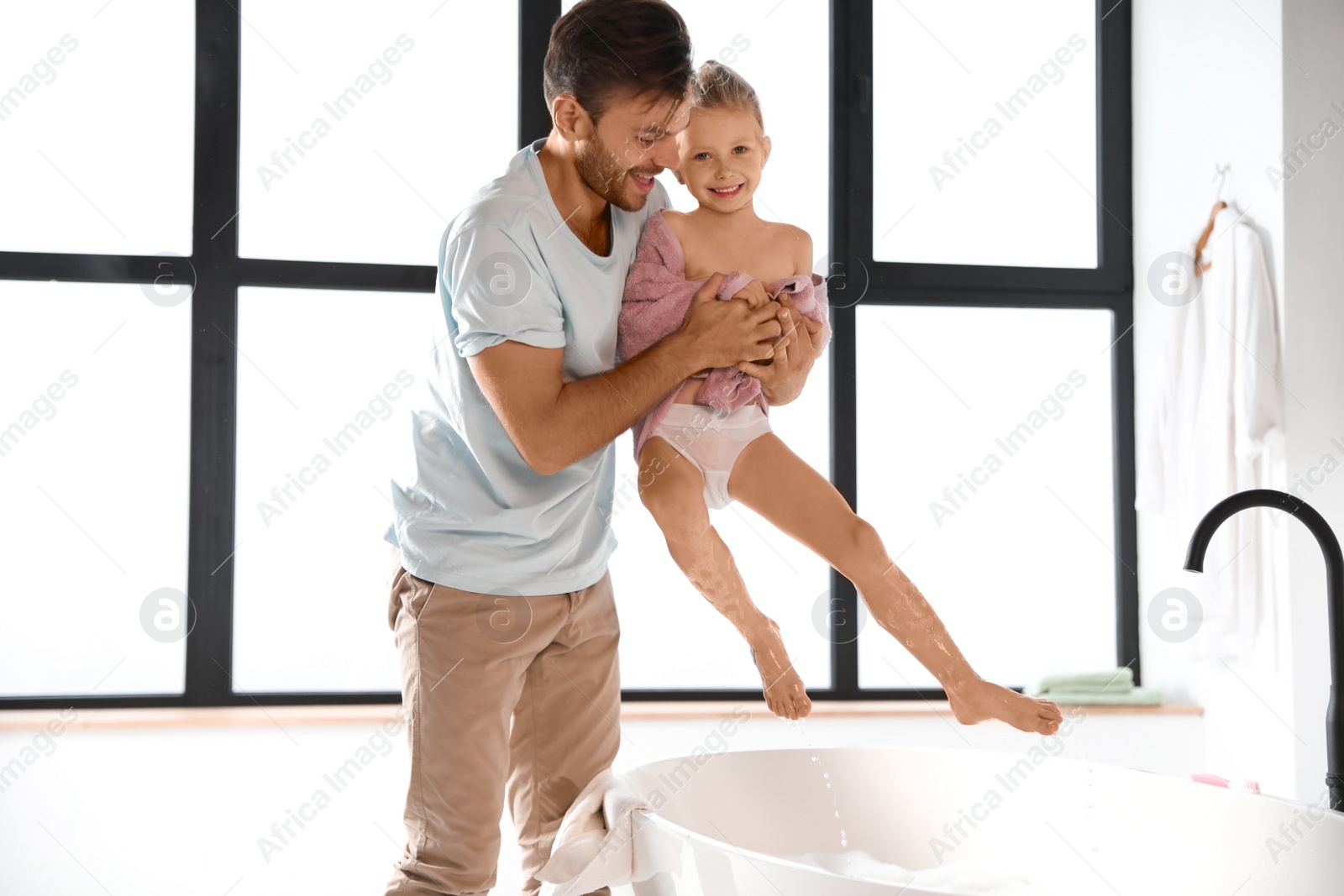 Father and his cute little daughter in bathroom Photo of Father and his cute little daughter in bathroom