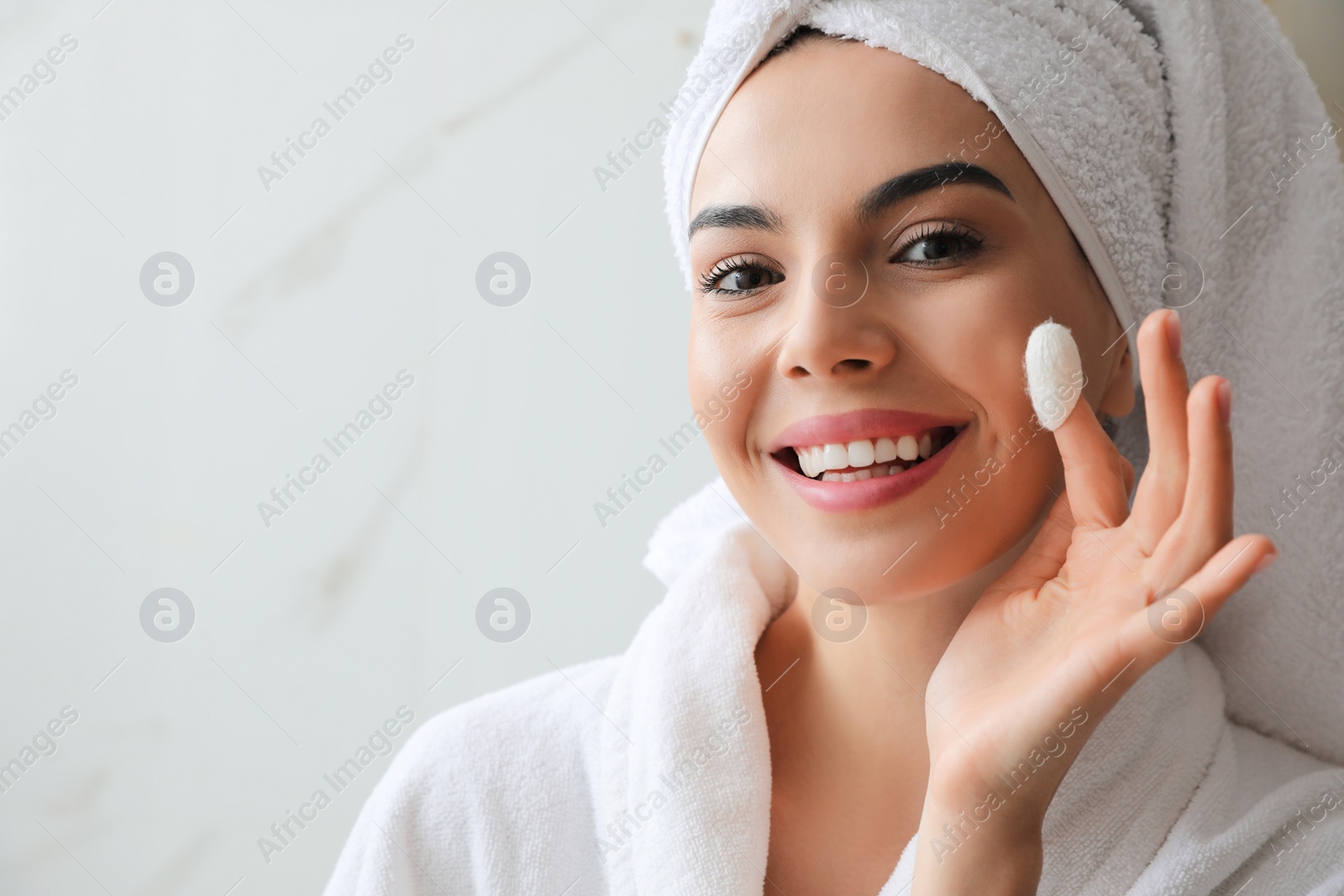 Woman using silkworm cocoon in skin care routine at home. Space for text Photo of Woman using silkworm cocoon in skin care routine at home. Space for text