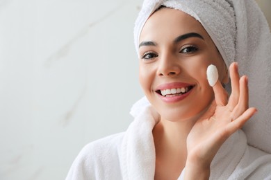 Woman using silkworm cocoon in skin care routine at home. Space for text Photo of Woman using silkworm cocoon in skin care routine at home. Space for text