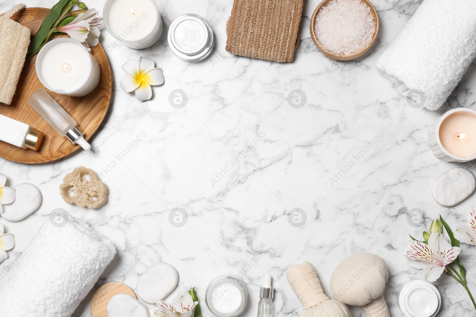 Frame of spa essentials on white marble background, flat lay. Space for text Photo of Frame of spa essentials on white marble background, flat lay. Space for text