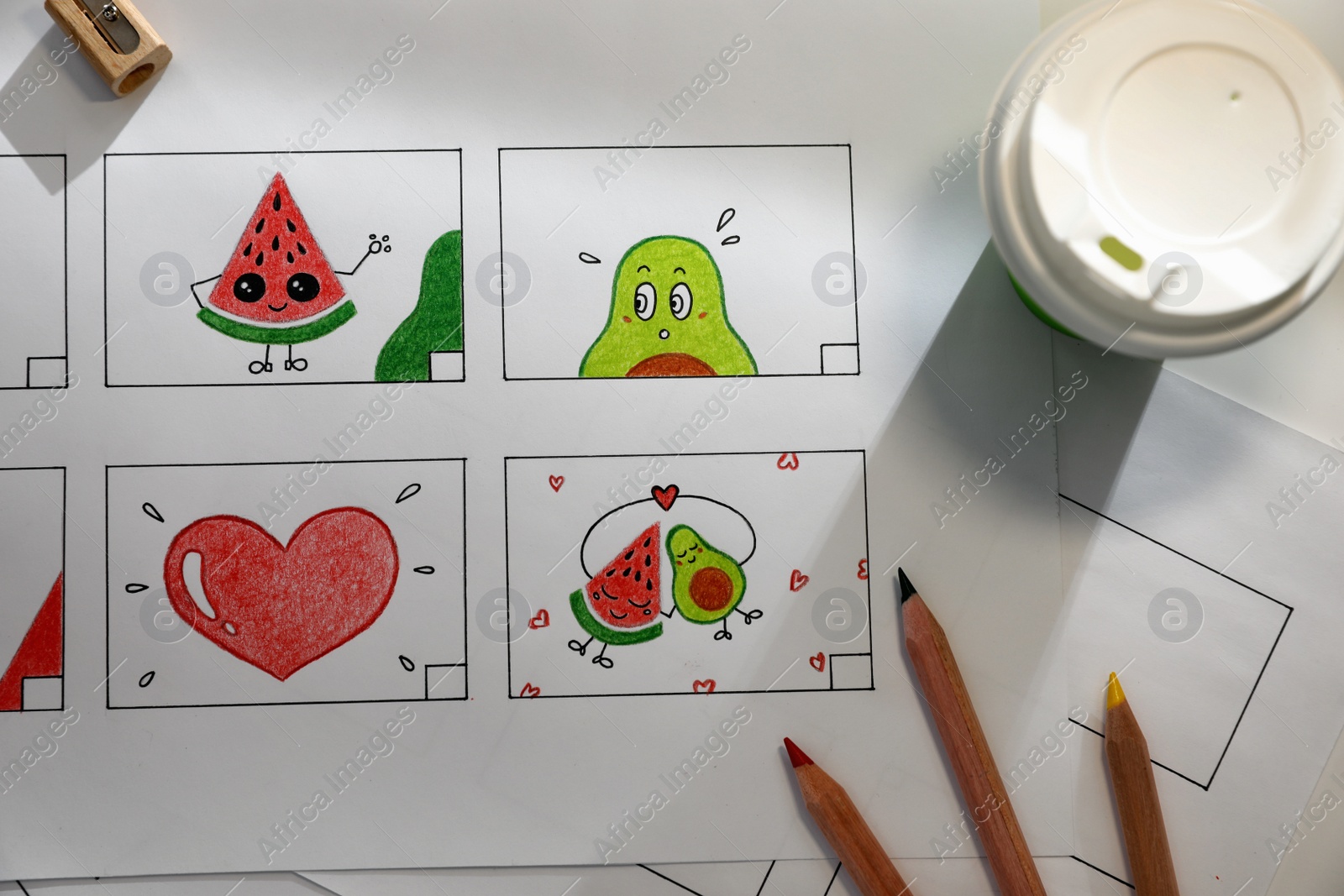 Storyboard with cartoon sketches at workplace, flat lay. Pre-production process Photo of Storyboard with cartoon sketches at workplace, flat lay. Pre-production process