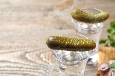 Cold Russian vodka with pickles on table, closeup Photo of Cold Russian vodka with pickles on table, closeup