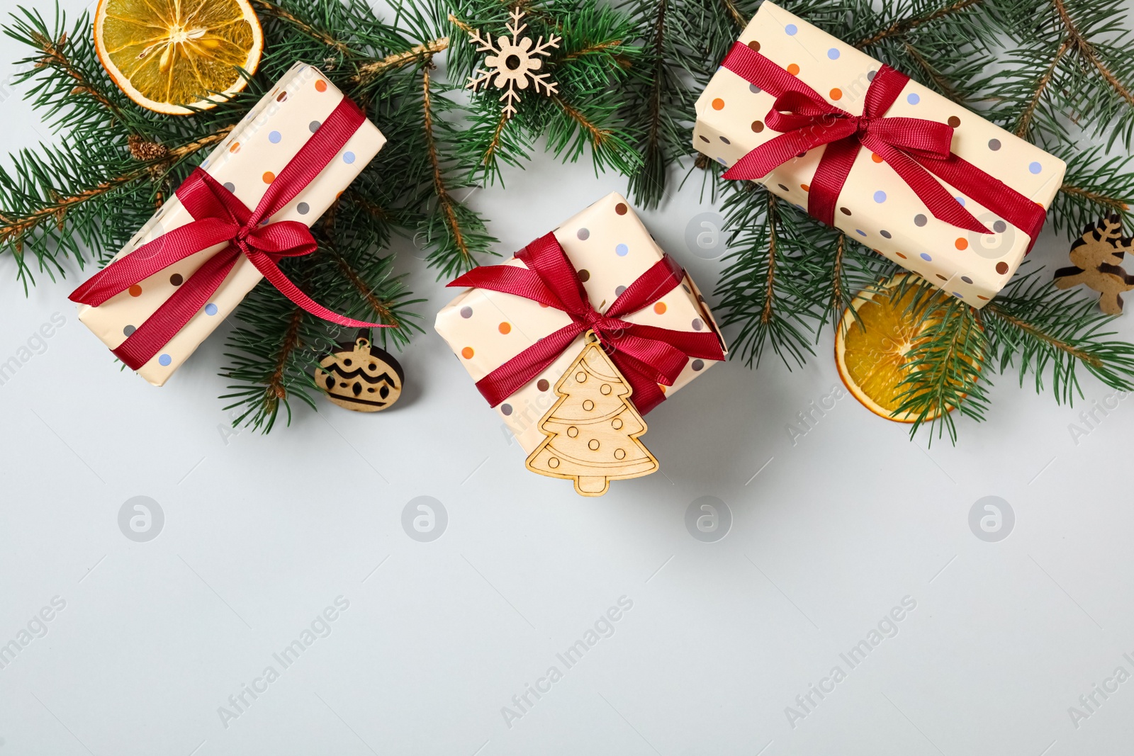 Flat lay composition with Christmas gift boxes and fir branches on grey background. Space for text Photo of Flat lay composition with Christmas gift boxes and fir branches on grey background. Space for text