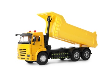 Yellow toy tipper truck isolated on white Photo of Yellow toy tipper truck isolated on white