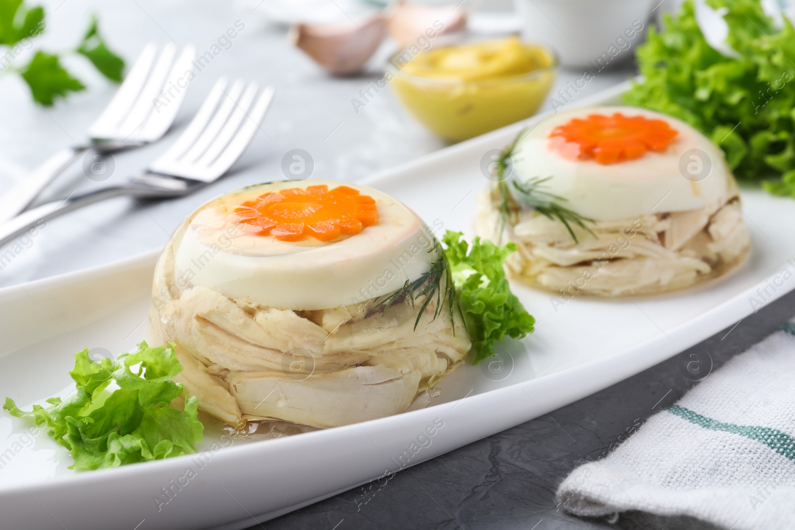 Delicious chicken aspic with eggs and vegetables on plate, closeup Photo of Delicious chicken aspic with eggs and vegetables on plate, closeup
