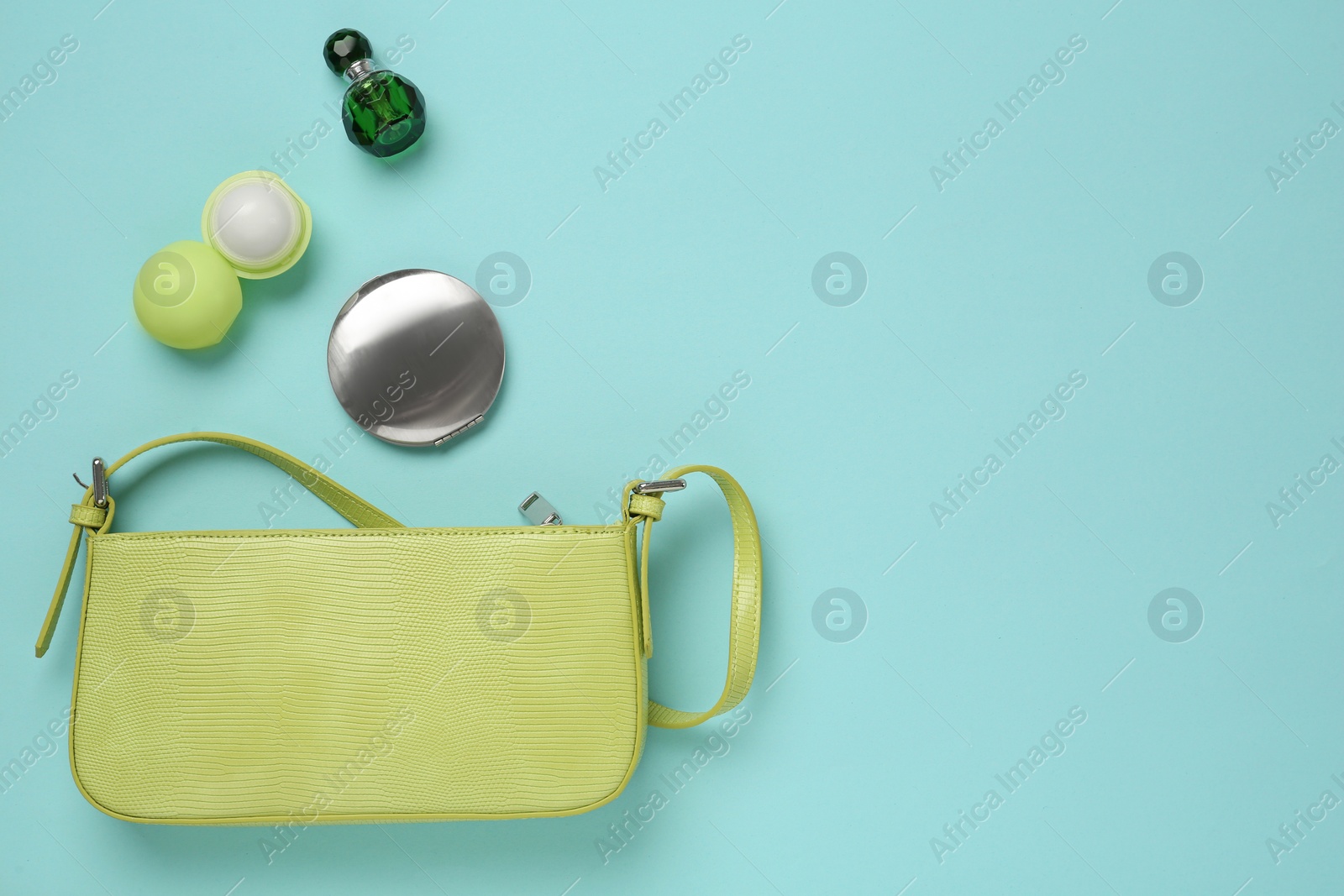Flat lay composition with stylish baguette handbag on light blue background. Space for text Photo of Flat lay composition with stylish baguette handbag on light blue background. Space for text